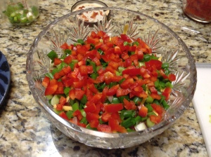 Then add salsa, sour cream, green onions, red peppers.
