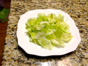 Break lettuce up into bite-sized pieces and place in taco bowl or on plate.